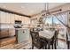 Bright eat-in kitchen featuring modern appliances, white cabinets, and an island at 12362 Nate Cir, Parker, CO 80134