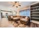 Inviting living room open to the kitchen, featuring built-in shelving and fireplace at 12362 Nate Cir, Parker, CO 80134