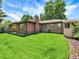 The exterior of the home is brick with a well-manicured lawn at 2046 S Quitman St, Denver, CO 80219