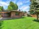 The exterior of the home has a shed in the backyard with a large lawn at 2046 S Quitman St, Denver, CO 80219