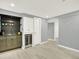 Basement kitchenette featuring custom cabinets and a wine fridge at 2046 S Quitman St, Denver, CO 80219