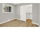 Bedroom with hardwood floors and sliding door closet at 2046 S Quitman St, Denver, CO 80219