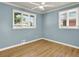 Bright bedroom with hardwood floors and two windows at 2046 S Quitman St, Denver, CO 80219