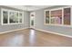 Bright, empty bedroom with hardwood floors, fresh paint, and lots of natural light from the windows at 2046 S Quitman St, Denver, CO 80219