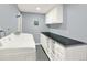 Spacious laundry room with white cabinets and countertop at 2046 S Quitman St, Denver, CO 80219