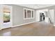 Open living room with hardwood floors, white trim, and views of the kitchen and backyard at 2046 S Quitman St, Denver, CO 80219