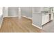 Bright living room featuring hardwood floors, white trim, and a large window at 2046 S Quitman St, Denver, CO 80219