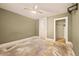 Spacious bedroom with ceiling fan, closet, and neutral paint in need of new flooring at 709 27Th St, Denver, CO 80205