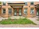 A close-up of brick townhome entrances with black iron railings and covered porches at 709 27Th St, Denver, CO 80205