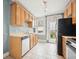 Functional kitchen with stainless steel appliances and white tiled flooring at 709 27Th St, Denver, CO 80205