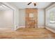 Bright room with hardwood floors, exposed brick, and large window at 709 27Th St, Denver, CO 80205