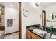 Bathroom vanity featuring granite counters and a lighted makeup mirror at 611 E 7Th Ave, Denver, CO 80203