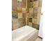 Stylish tub with stone tile surround at 611 E 7Th Ave, Denver, CO 80203