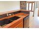 Well-appointed kitchen with a dishwasher, sink, granite countertops, and wood cabinets at 611 E 7Th Ave, Denver, CO 80203