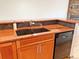 Modern kitchen features a double sink, updated appliances, granite countertops, and custom cabinetry at 611 E 7Th Ave, Denver, CO 80203