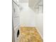 Laundry room featuring stacked washer and dryer with tile floors at 611 E 7Th Ave, Denver, CO 80203