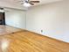 Spacious living room with a full wall mirror, hardwood floors, and good light at 611 E 7Th Ave, Denver, CO 80203