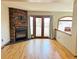 Inviting living room has hardwood floors, stone fireplace, french doors, and bright windows at 611 E 7Th Ave, Denver, CO 80203
