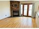 Bright living room boasts a stone fireplace, hardwood floors, and french doors to outside at 611 E 7Th Ave, Denver, CO 80203
