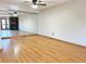 Bright living room with hardwood floors, a full wall mirror, and modern ceiling fan at 611 E 7Th Ave, Denver, CO 80203