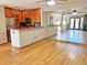 Open living room with hardwood floors, breakfast bar, kitchen, and open floor plan at 611 E 7Th Ave, Denver, CO 80203