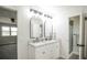 Bright bathroom featuring a dual sink vanity with black accents and a separate shower and bedroom views at 1409 S Moline St, Aurora, CO 80012