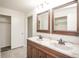 Bright bathroom featuring a double sink vanity and closets at 1409 S Moline St, Aurora, CO 80012