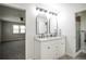 Bright bathroom featuring a double sink vanity with granite counters, and separate shower and bedroom views at 1409 S Moline St, Aurora, CO 80012