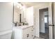 Bright bathroom with a single vanity with white granite countertops, modern fixtures, and ample storage at 1409 S Moline St, Aurora, CO 80012