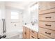 Bright bathroom features a white vanity and storage tower with black hardware at 1409 S Moline St, Aurora, CO 80012