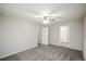 Bright bedroom boasts neutral carpet, paint, and modern ceiling fan and light fixture at 1409 S Moline St, Aurora, CO 80012