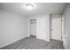 Clean bedroom with neutral carpet, paint, closet with sliding doors, and light fixture at 1409 S Moline St, Aurora, CO 80012