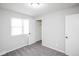 Neutral bedroom with window, neutral carpet, paint, closet, and ceiling light fixture at 1409 S Moline St, Aurora, CO 80012