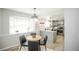 Cozy breakfast nook with modern light fixture and a view of the kitchen with stainless steel appliances at 1409 S Moline St, Aurora, CO 80012