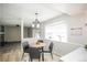 Bright breakfast nook featuring modern lighting, a bay window, and table with seating for four at 1409 S Moline St, Aurora, CO 80012