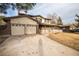 Attractive two-story home with a spacious driveway, well-kept lawn, and inviting front porch at 1409 S Moline St, Aurora, CO 80012