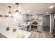 Well-lit kitchen featuring white countertops, stainless steel appliances, and light-gray cabinets at 1409 S Moline St, Aurora, CO 80012