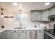 Well-appointed kitchen featuring light-gray cabinetry, stainless steel appliances, and bright lighting at 1409 S Moline St, Aurora, CO 80012
