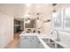 Bright kitchen features quartz countertops, stainless steel sink, and modern pendant lighting at 1409 S Moline St, Aurora, CO 80012