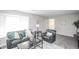 Inviting living room with large bay window, comfortable seating, and neutral-toned walls at 1409 S Moline St, Aurora, CO 80012