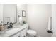 Well-lit powder room with a granite countertop, black hardware and a modern vanity at 1409 S Moline St, Aurora, CO 80012
