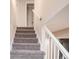 Carpeted staircase with white railings leads to the upper level of the home at 1409 S Moline St, Aurora, CO 80012