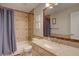 Bathroom with a mosaic-trimmed mirror, shower, and a vanity sink at 19414 E Mann Creek Dr # C, Parker, CO 80134
