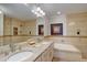 Luxurious bathroom with dual sinks, tub, and tiled shower at 19414 E Mann Creek Dr # C, Parker, CO 80134