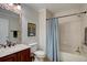 Well-lit bathroom with a shower-tub combo, single sink vanity, and modern fixtures at 19414 E Mann Creek Dr # C, Parker, CO 80134
