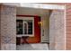 Charming entrance with brick pillars and a cozy seating area at 19414 E Mann Creek Dr # C, Parker, CO 80134