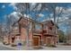 Townhome featuring a two-car garage, balcony, and street appeal thanks to the architectural design and mature landscaping at 19414 E Mann Creek Dr # C, Parker, CO 80134
