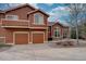Exterior view of a home featuring a two-car garage, a balcony, and a patio at 19414 E Mann Creek Dr # C, Parker, CO 80134