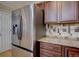 Kitchen showcasing modern stainless steel refrigerator and wooden cabinets at 19414 E Mann Creek Dr # C, Parker, CO 80134