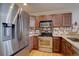Modern kitchen featuring stainless steel appliances and wooden cabinetry at 19414 E Mann Creek Dr # C, Parker, CO 80134